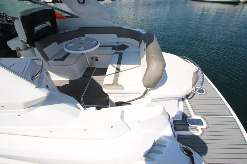  Yacht Photos Pics 2018 Monterey 295 Sport Yacht interior with seating and table, docked on calm water.