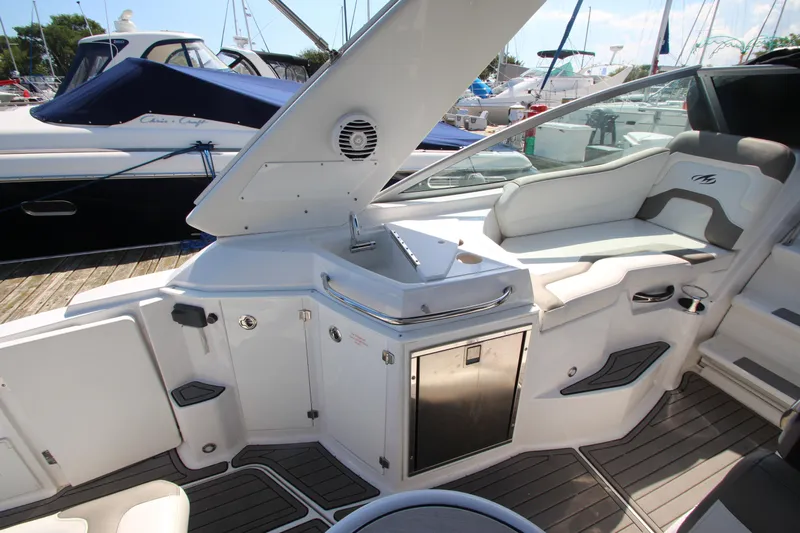  Yacht Photos Pics 2018 Monterey 295 Sport Yacht interior with seating and kitchenette on a sunny day.