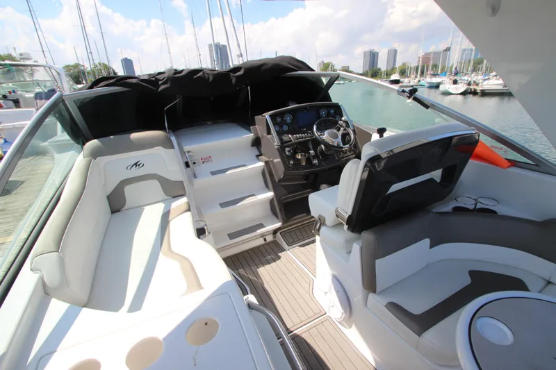  Yacht Photos Pics 2018 Monterey 295 Sport Yacht interior with helm, seating, and marina view.