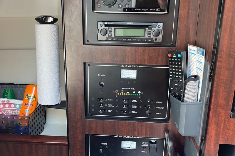  Yacht Photos Pics Control panel of a 2018 Monterey 295 Sport Yacht with electronics and storage compartments.