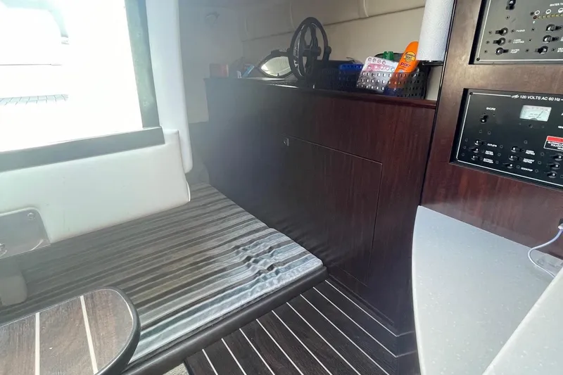  Yacht Photos Pics Interior of 2018 Monterey 295 Sport Yacht with striped seating and control panel.