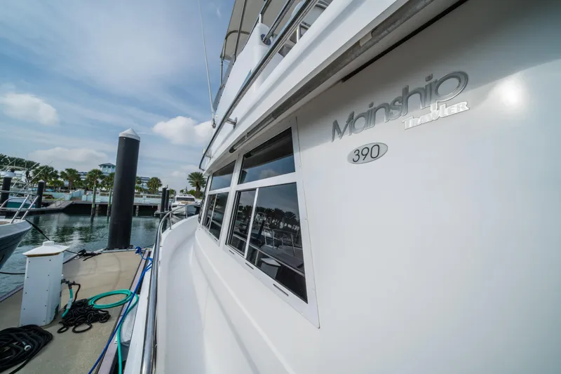 Sea Bandit Yacht Photos Pics 2003 Mainship 390 Trawler docked at marina under blue sky.