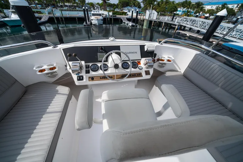 Sea Bandit Yacht Photos Pics 2003 Mainship 390 Trawler helm with Garmin navigation, docked at marina.