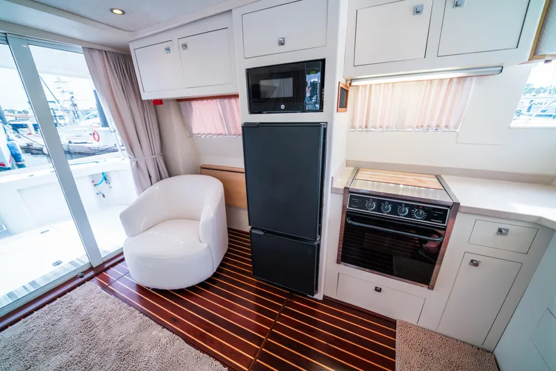 Sea Bandit Yacht Photos Pics Interior of 2003 Mainship 390 Trawler with modern kitchen and cozy seating area.