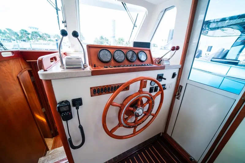 Sea Bandit Yacht Photos Pics 2003 Mainship 390 Trawler helm with wooden wheel and control panel.