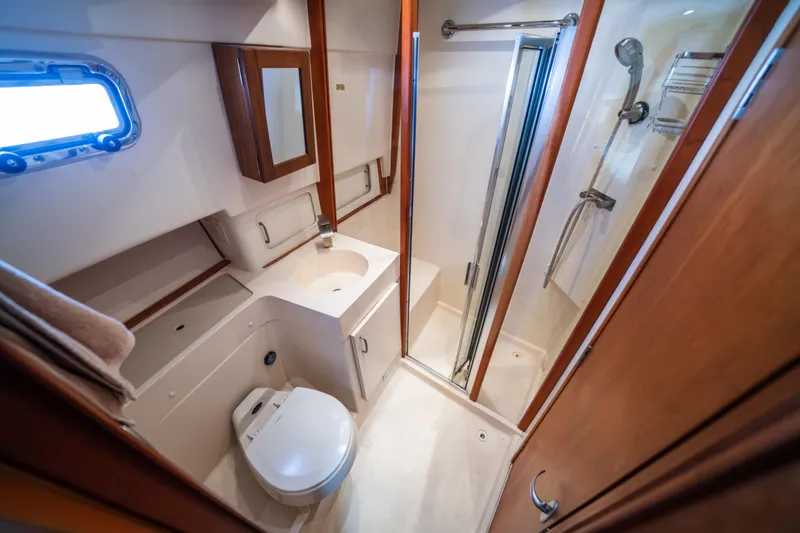 Sea Bandit Yacht Photos Pics Bathroom interior of 2003 Mainship 390 Trawler with shower, sink, and toilet.