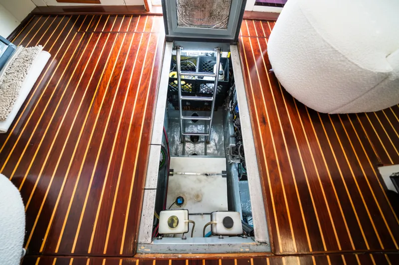 Sea Bandit Yacht Photos Pics Engine compartment of 2003 Mainship 390 Trawler with polished wooden flooring.