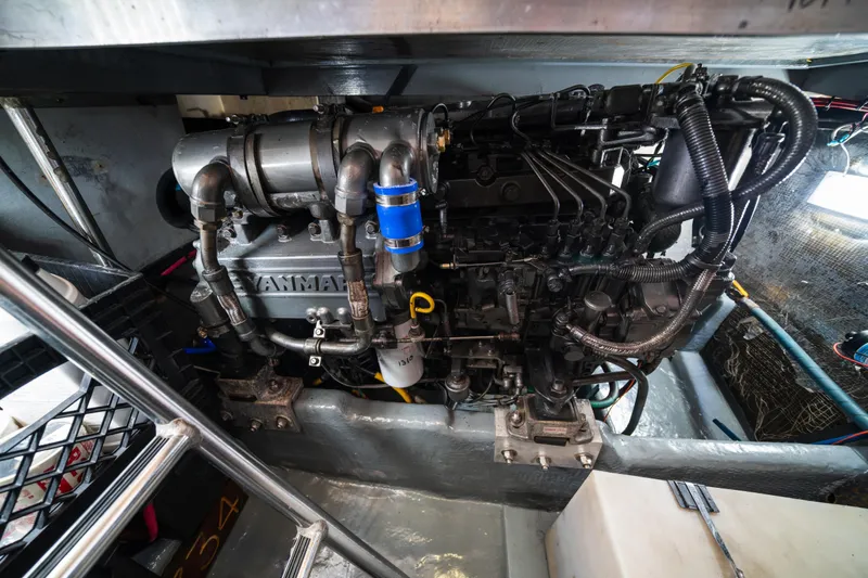 Sea Bandit Yacht Photos Pics Engine compartment of a 2003 Mainship 390 Trawler, featuring a Yanmar marine engine.