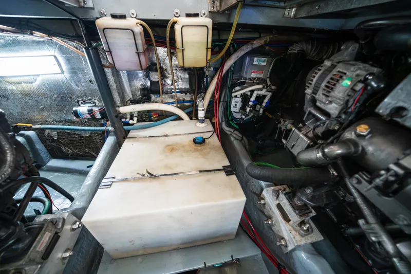 Sea Bandit Yacht Photos Pics Engine room of a 2003 Mainship 390 Trawler, showcasing mechanical components and wiring.