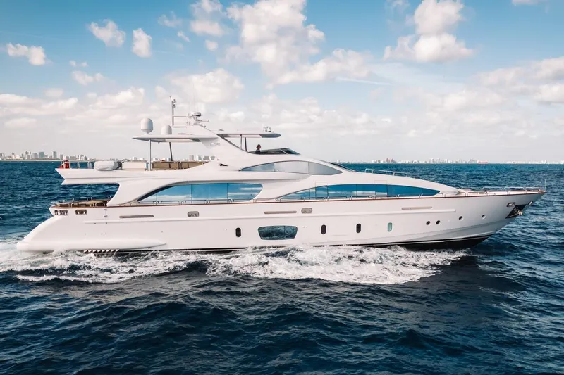 Amanecer Yacht Photos Pics Luxurious 2009 Azimut 105 yacht cruising on open sea under blue sky.