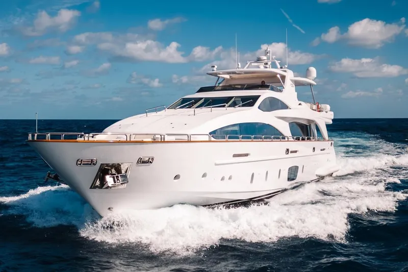 Amanecer Yacht Photos Pics Luxurious 2009 Azimut 105 yacht cruising on open sea under blue skies.