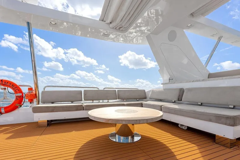 Amanecer Yacht Photos Pics Luxurious seating area on 2009 Azimut 105 yacht with ocean view and blue sky.