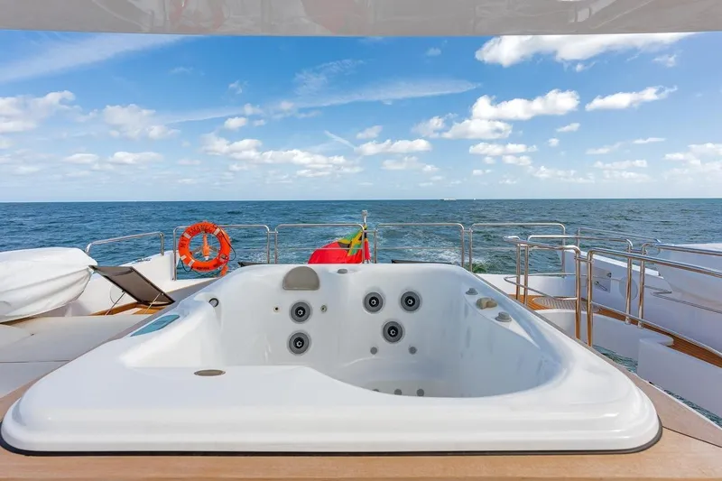 Amanecer Yacht Photos Pics Luxurious jacuzzi on 2009 Azimut 105 yacht with ocean view and clear skies.