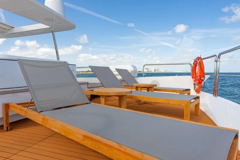 Amanecer Yacht Photos Pics Sun deck of 2009 Azimut 105 yacht with loungers and ocean view.