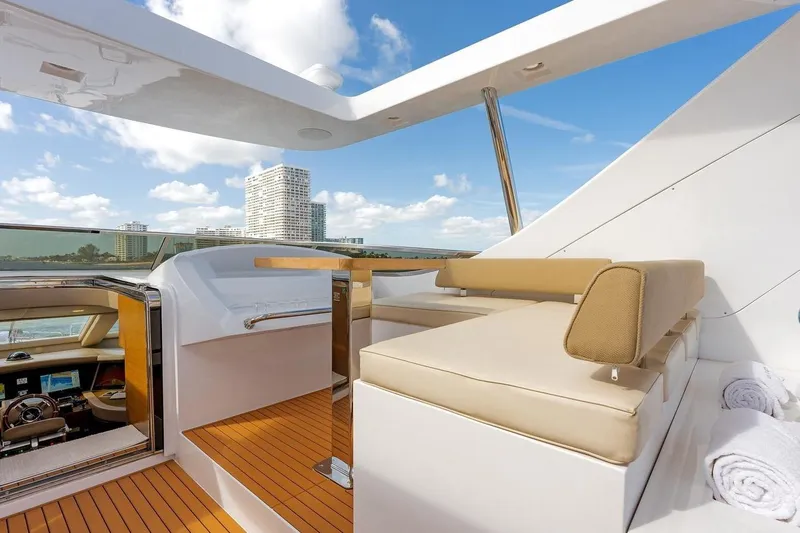 Amanecer Yacht Photos Pics Luxurious 2009 Azimut 105 yacht deck with seating, city skyline view.