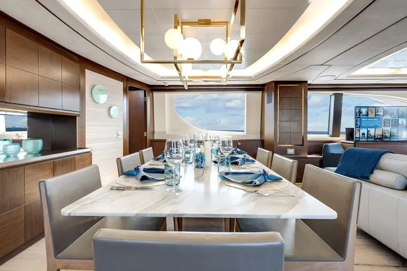 Amanecer Yacht Photos Pics Luxurious dining area on 2009 Azimut 105 yacht with elegant table setting and modern decor.