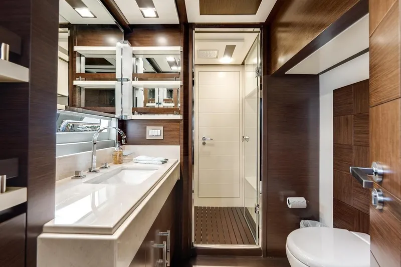 Amanecer Yacht Photos Pics Luxurious bathroom interior of 2009 Azimut 105 yacht with modern fixtures and wood accents.