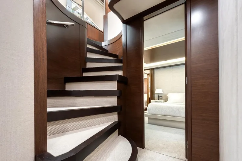 Amanecer Yacht Photos Pics Luxurious interior of 2009 Azimut 105 yacht featuring elegant staircase and cozy bedroom.