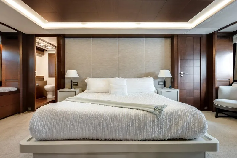 Amanecer Yacht Photos Pics Luxurious bedroom interior on 2009 Azimut 105 yacht, featuring elegant design and modern amenities.