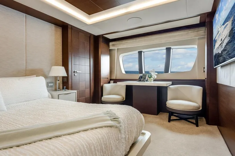 Amanecer Yacht Photos Pics Luxurious bedroom interior on 2009 Azimut 105 yacht with ocean view and elegant furnishings.