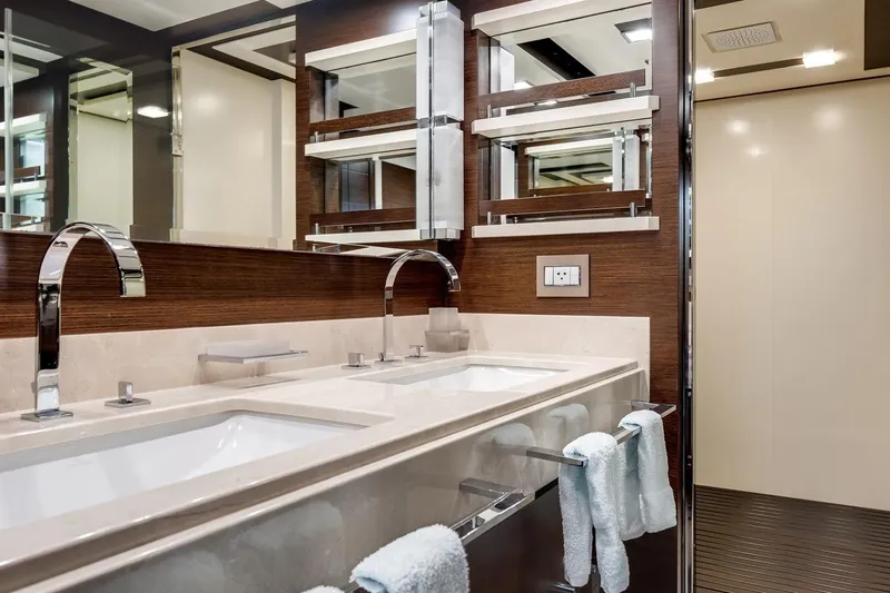 Amanecer Yacht Photos Pics Luxurious bathroom with dual sinks in a 2009 Azimut 105 yacht, featuring modern fixtures and elegant design.