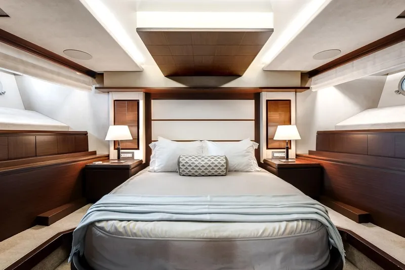 Amanecer Yacht Photos Pics Luxurious bedroom interior of 2009 Azimut 105 yacht with elegant wood accents.
