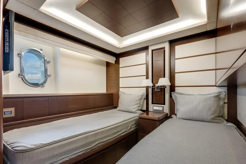 Amanecer Yacht Photos Pics Luxurious twin cabin interior of 2009 Azimut 105 yacht with modern design and porthole view.