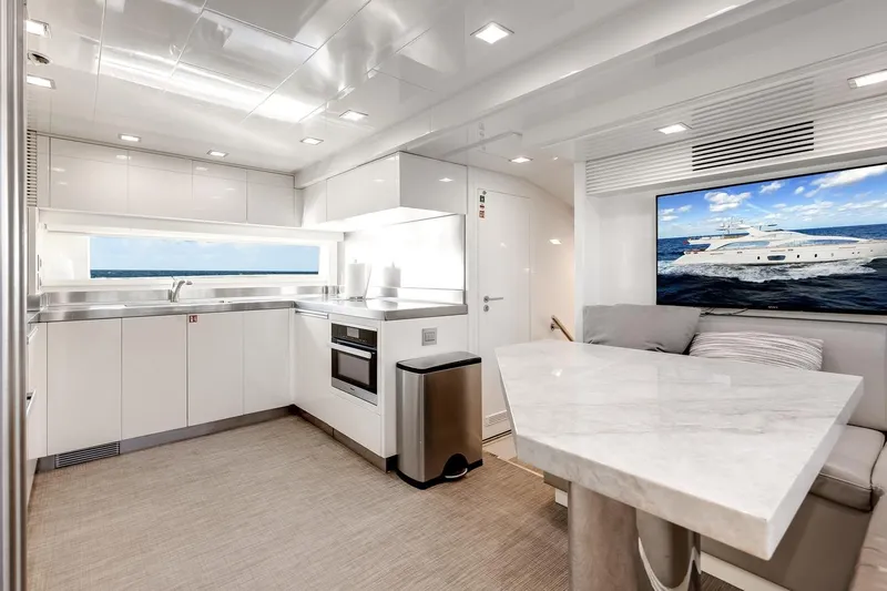 Amanecer Yacht Photos Pics Luxurious 2009 Azimut 105 yacht interior with modern kitchen and seating area.