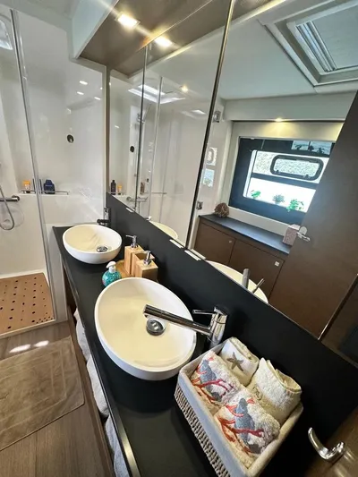 Hayat Yacht Photos Pics Modern bathroom in 2021 Nautitech 46 Fly catamaran with dual sinks and large mirror.