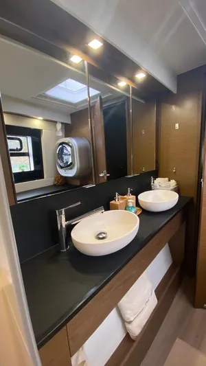 Hayat Yacht Photos Pics Modern bathroom in a 2021 Nautitech 46 Fly catamaran with dual sinks and sleek design.
