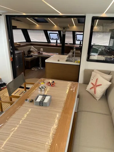 Hayat Yacht Photos Pics Interior of 2021 Nautitech 46 Fly catamaran with modern dining and kitchen area.