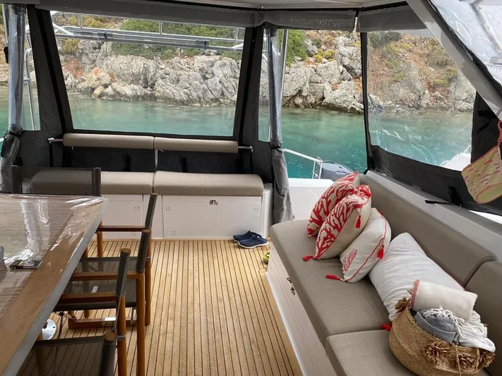 Hayat Yacht Photos Pics Interior of 2021 Nautitech 46 Fly yacht with comfortable seating and scenic water view.