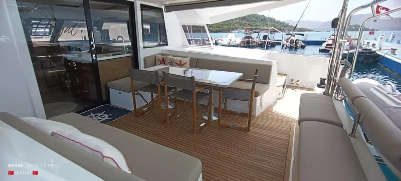 Hayat Yacht Photos Pics Spacious deck of 2021 Nautitech 46 Fly catamaran with seating and dining area.