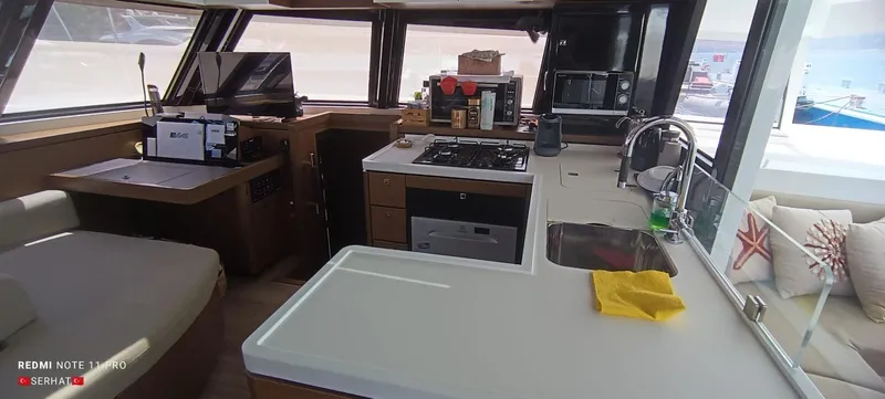 Hayat Yacht Photos Pics Interior of 2021 Nautitech 46 Fly yacht with modern kitchen and seating area.