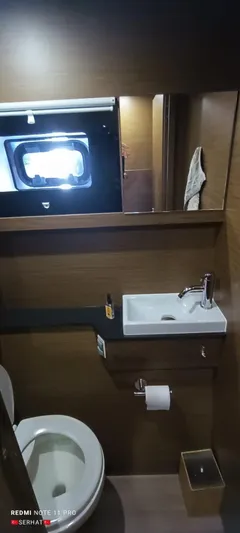 Hayat Yacht Photos Pics Modern bathroom in 2021 Nautitech 46 Fly yacht with sink and toilet.