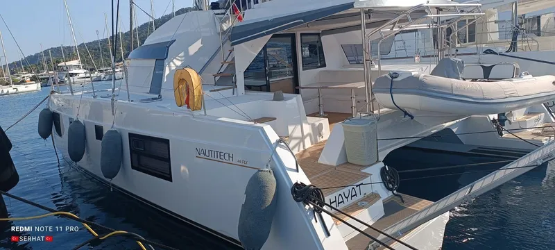 Hayat Yacht Photos Pics Nautitech 46 Fly 2021 catamaran docked at marina with inflatable boat.