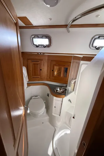 North Sound Yacht Photos Pics Luxurious 2024 Tartan 455 yacht bathroom with wooden cabinetry and modern fixtures.