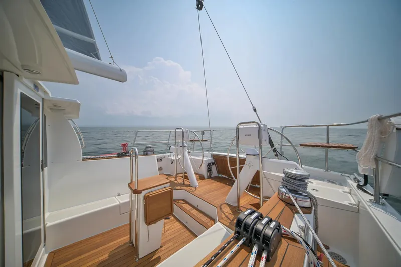 North Sound Yacht Photos Pics 2024 Tartan 455 sailboat deck with wooden flooring, ocean view, and clear sky.