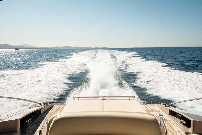  Yacht Photos Pics Riva 63 Vertigo yacht cruising on open sea, leaving a wake behind, 2009 model.