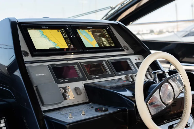  Yacht Photos Pics Cockpit of 2009 Riva 63 Vertigo yacht with navigation screens and steering wheel.