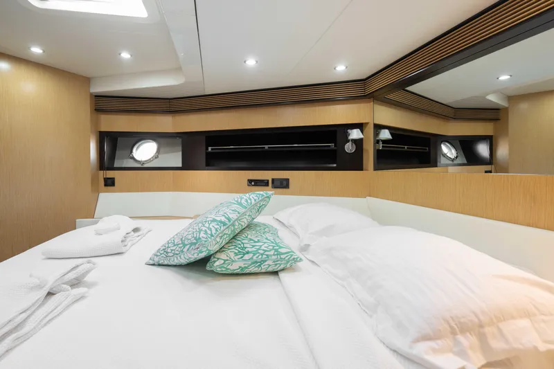  Yacht Photos Pics Luxurious bedroom interior of 2009 Riva 63 Vertigo yacht with modern design and cozy bedding.