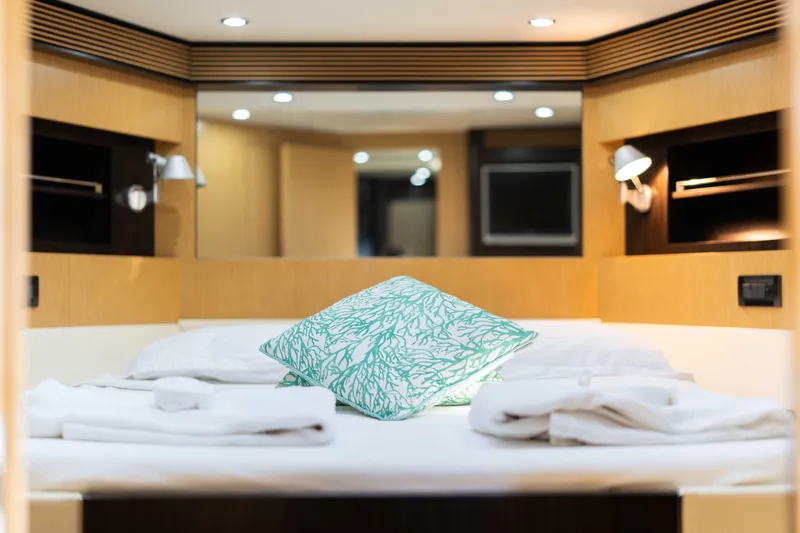  Yacht Photos Pics Luxurious cabin interior of 2009 Riva 63 Vertigo yacht with elegant bedding.