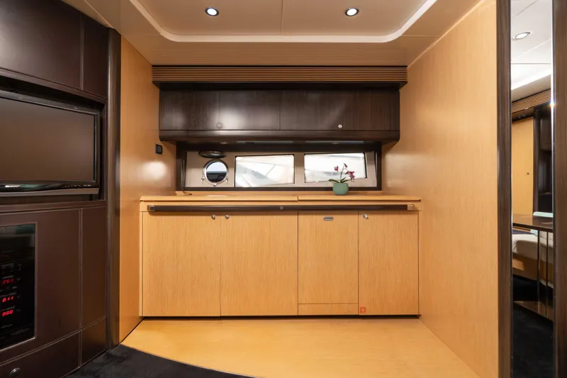  Yacht Photos Pics Interior of 2009 Riva 63 Vertigo yacht with modern wood cabinetry and porthole window.