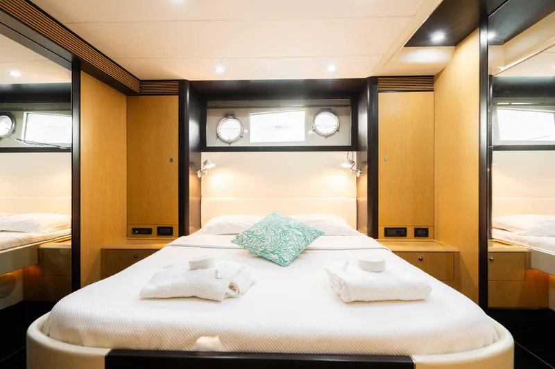  Yacht Photos Pics Luxurious cabin interior of 2009 Riva 63 Vertigo yacht with elegant wood finishes.