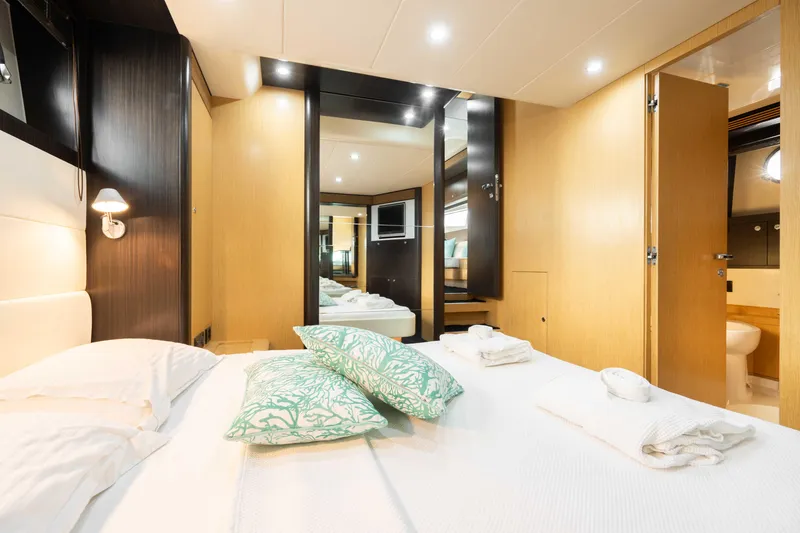  Yacht Photos Pics Luxurious bedroom interior of 2009 Riva 63 Vertigo yacht with modern design and elegant decor.