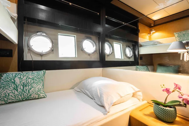  Yacht Photos Pics Luxurious cabin interior of 2009 Riva 63 Vertigo yacht with portholes and elegant decor.