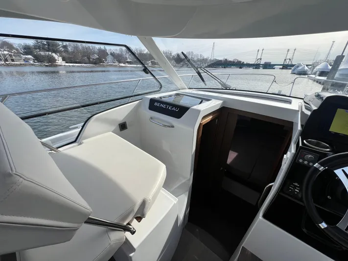  Yacht Photos Pics Interior view of 2020 Beneteau Antares 9 boat, featuring helm and seating area.
