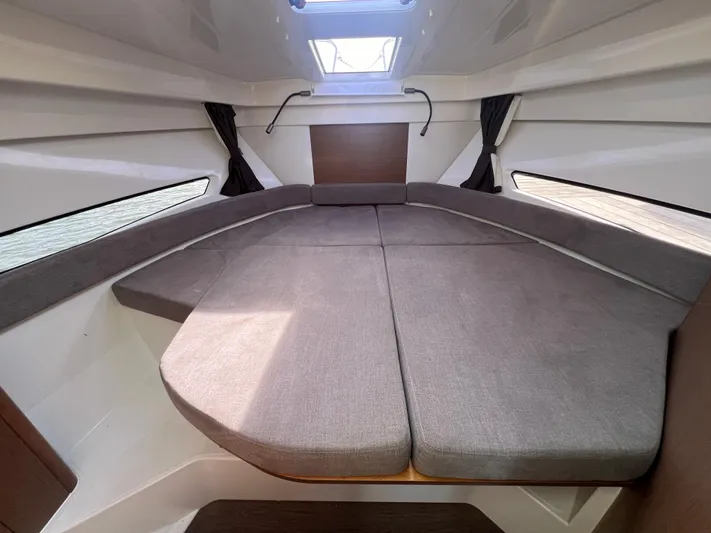  Yacht Photos Pics 2020 Beneteau Antares 9 cabin interior with spacious bed and skylight.