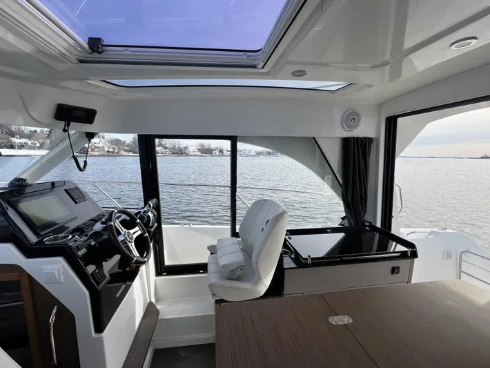  Yacht Photos Pics Interior of 2020 Beneteau Antares 9 boat with steering wheel and water view.