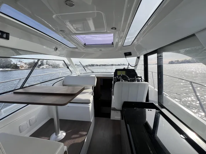  Yacht Photos Pics Interior of 2020 Beneteau Antares 9 boat with modern seating and navigation area.